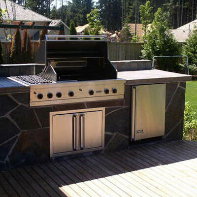 Create a unique space in your backyard with an outdoor grill and kitchen designed by Bonney Lake Landscapes in Seattle, Washington.